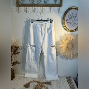 Women’s white high waist cargo jeans with side thigh cutout.